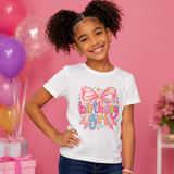 Cream Birthday Girl t-shirt with colorful rainbow bow graphic